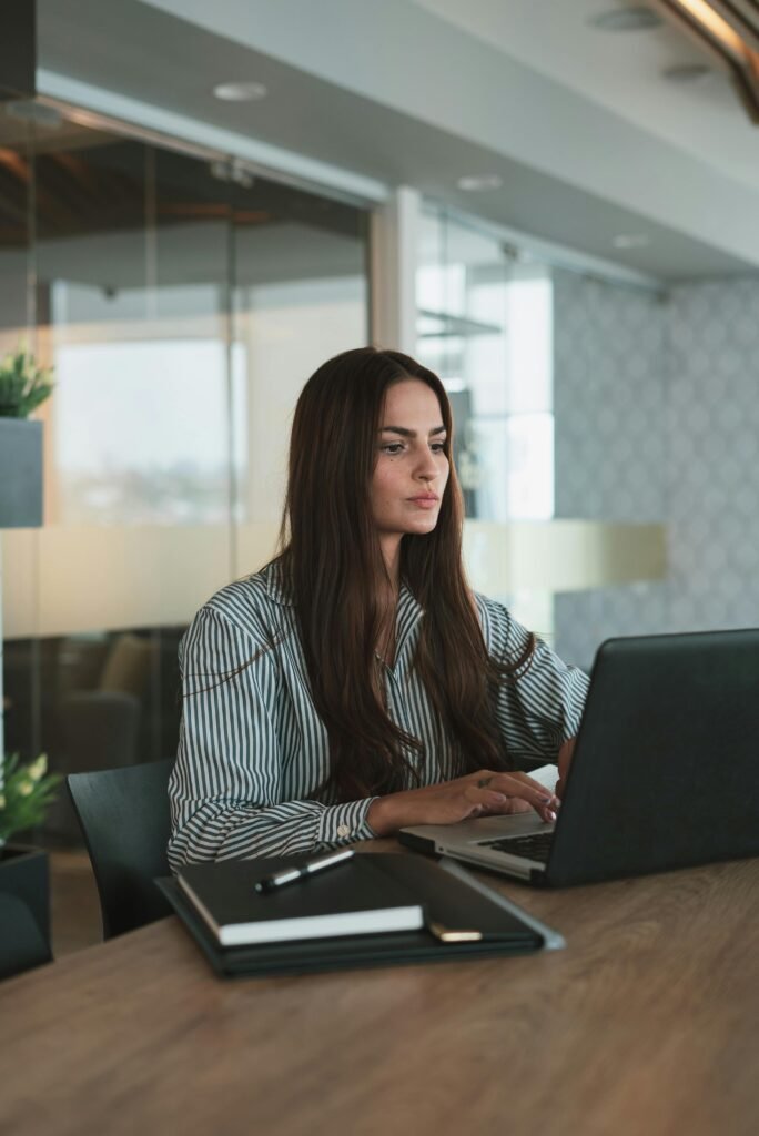 pexels-photo-10041233-10041233 Focused businesswoman typing on laptop in a stylish, modern office setting.